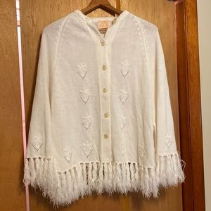 Women’s knit front button poncho with fringe, hand holes with flower embroidery